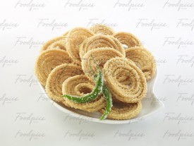 Chakli Plate of spiral fried dough snack with chili preview