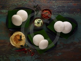 Idli Steamed rice cakes with various chutneys & papadams image preview